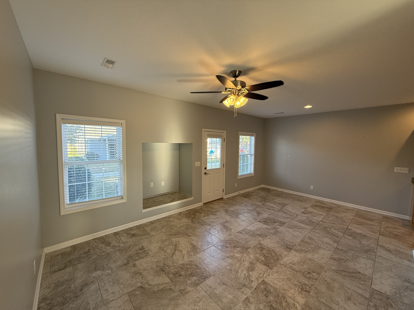 1603 Riverside Circle Dixon, IL 61021 - Photo 4 of 20 a view of an empty room with a chandelier fan and a window