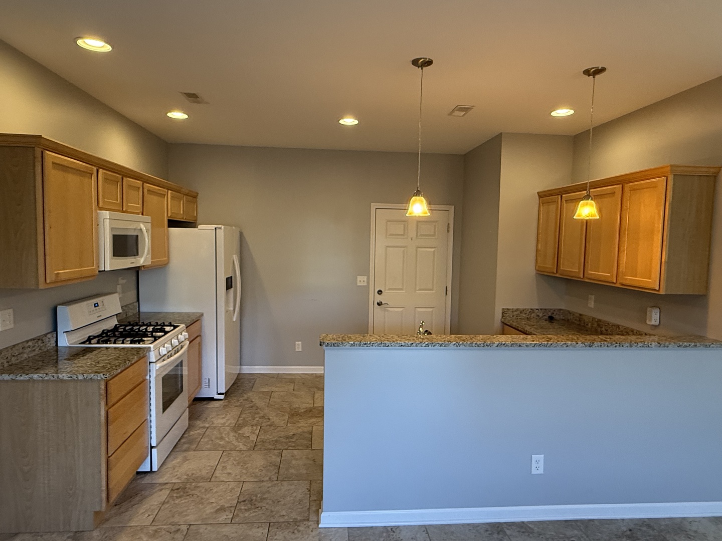 1603 Riverside Circle Dixon, IL 61021 - Photo 5 of 20 a kitchen with stainless steel appliances kitchen island granite countertop a refrigerator a stove and a sink