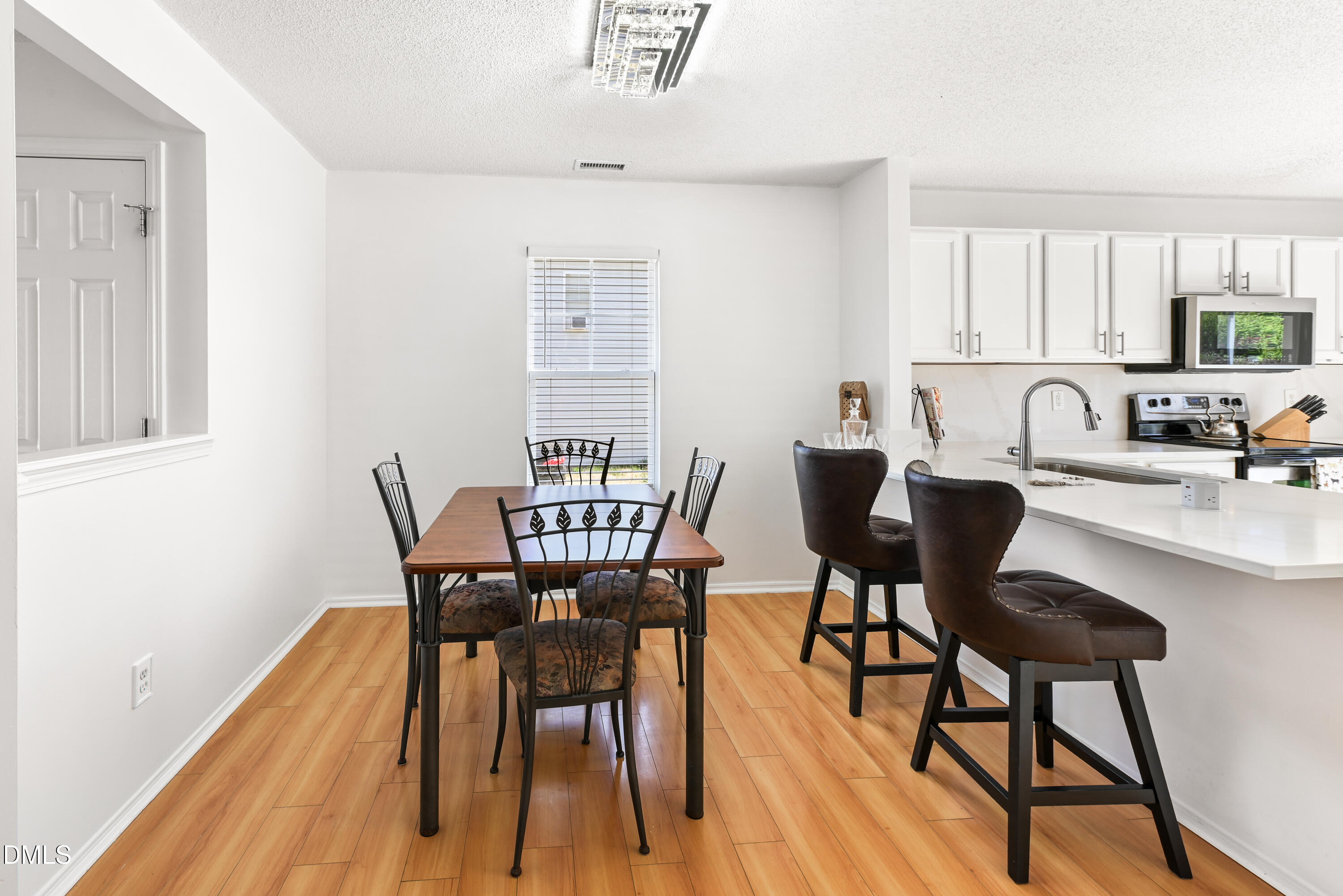 1012 Naylor Road Knightdale, NC 27545 - Photo 8 of 33 a view of a a dining room with furniture window and wooden floor