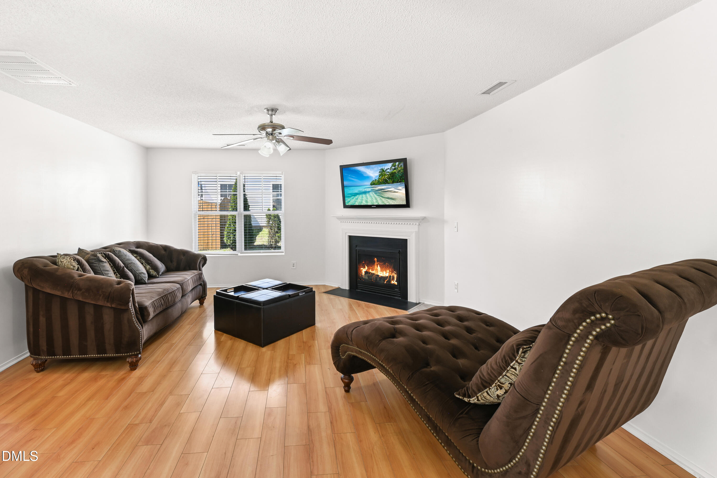 1012 Naylor Road Knightdale, NC 27545 - Photo 10 of 33 a bedroom with a bed lamp and a fireplace
