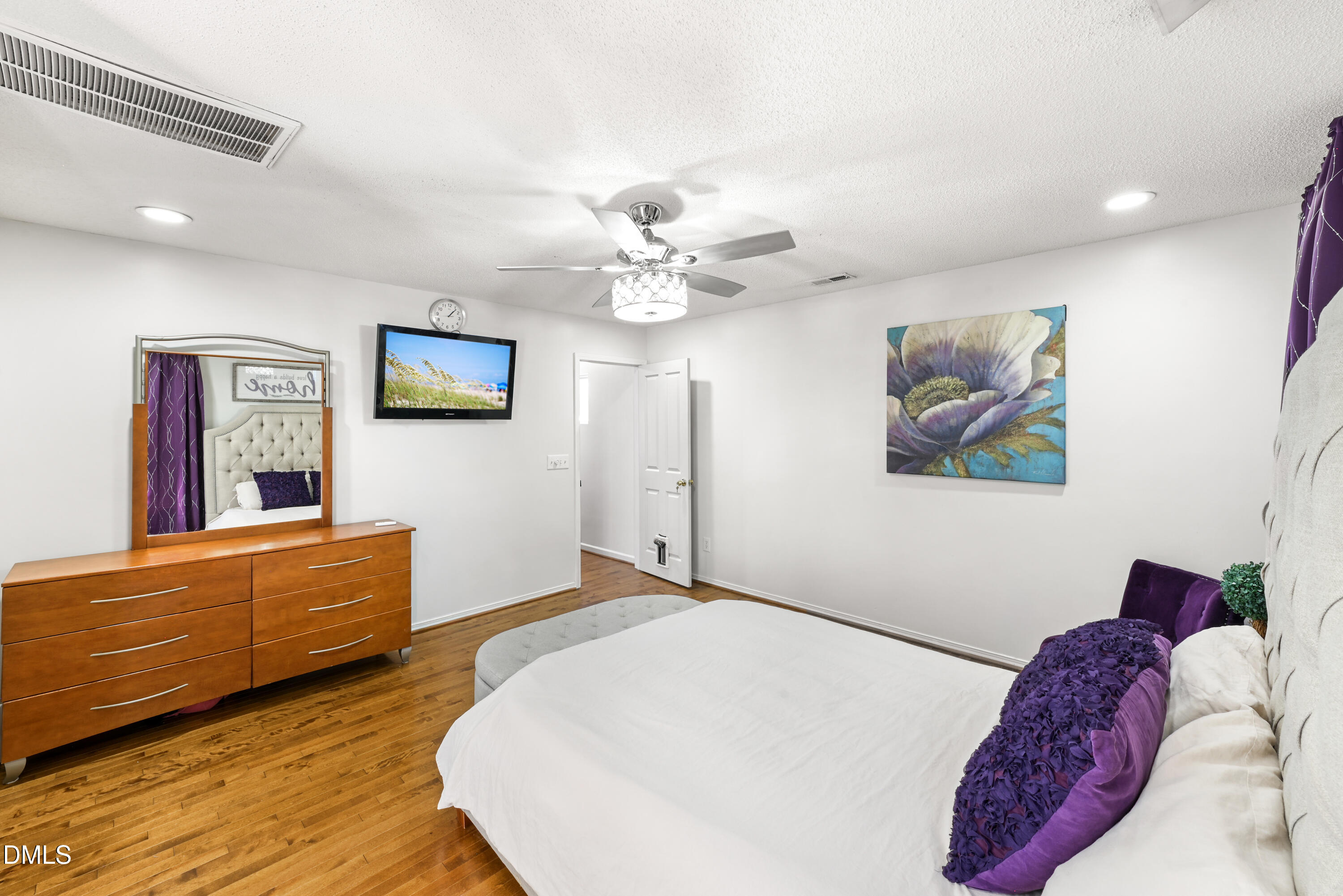 1012 Naylor Road Knightdale, NC 27545 - Photo 14 of 33 a bedroom with a bed and a chandelier