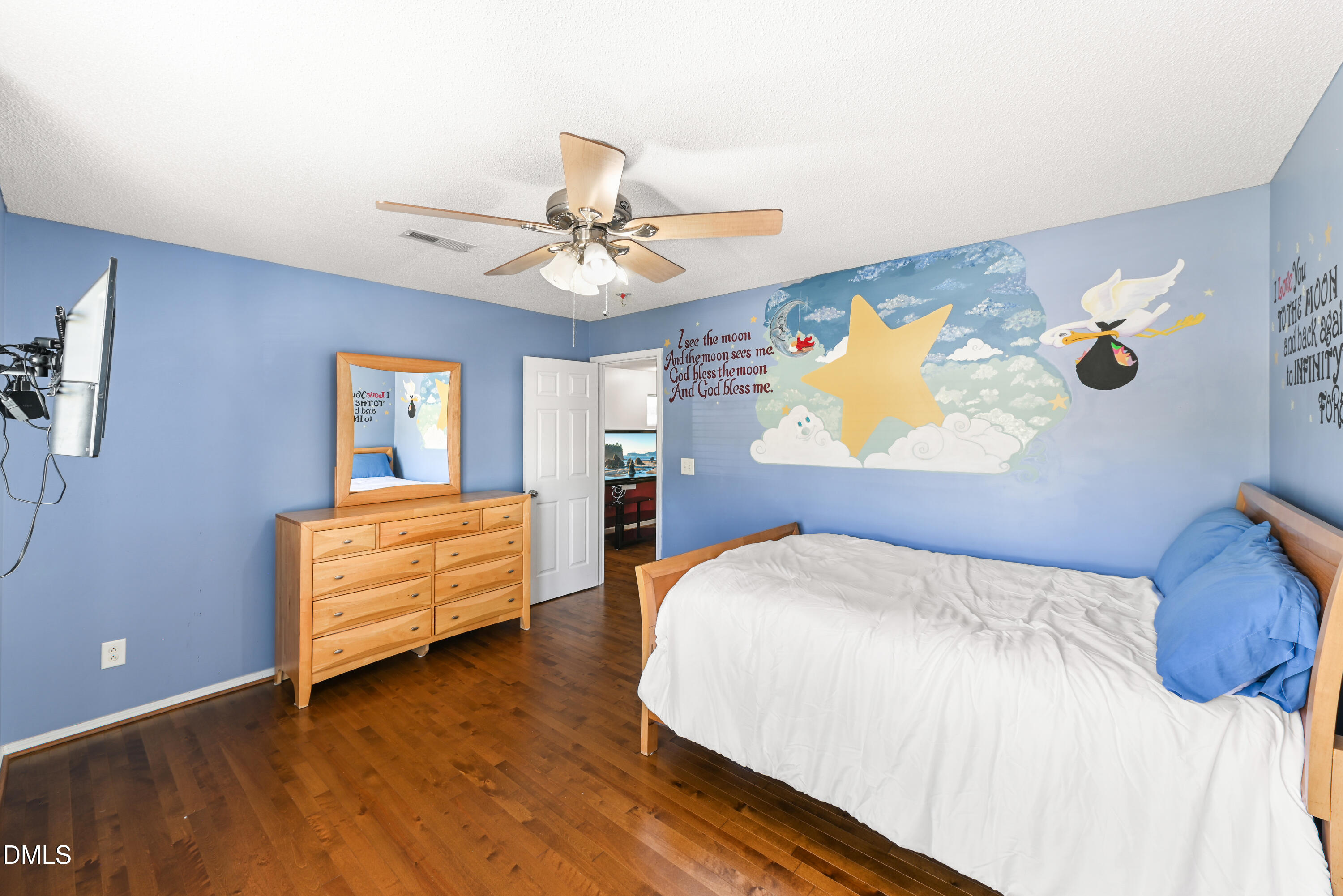 1012 Naylor Road Knightdale, NC 27545 - Photo 24 of 33 a bedroom with a bed dresser and wooden floor