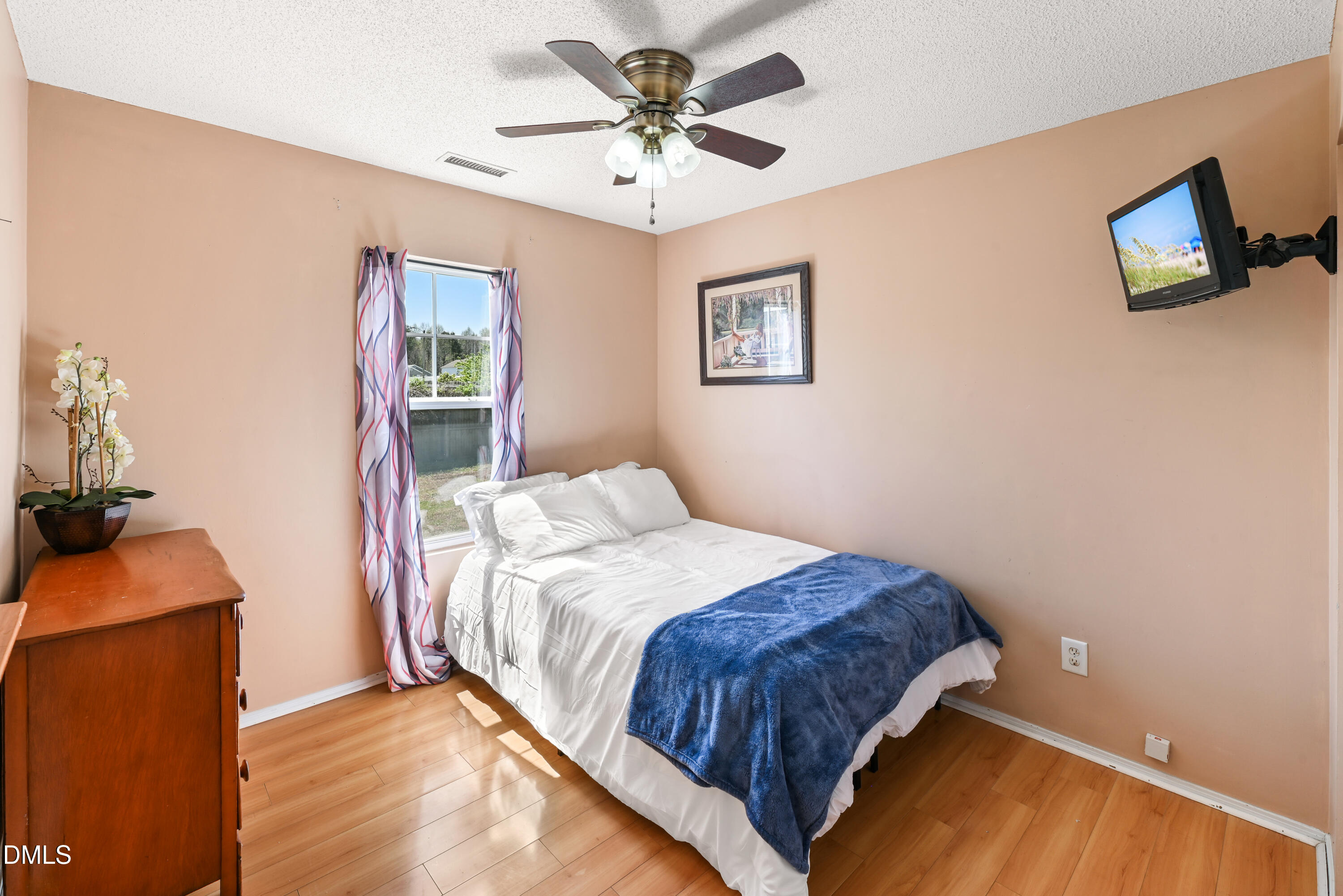 1012 Naylor Road Knightdale, NC 27545 - Photo 26 of 33 a bedroom with a bed and a chandelier