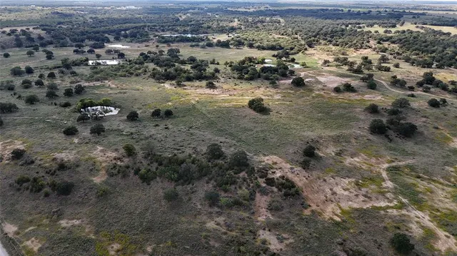 an aerial view of house with a yard