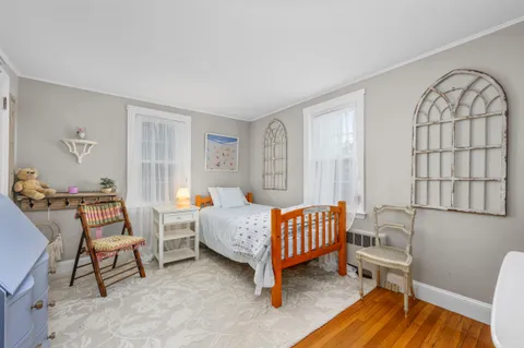 a bedroom with a bed and a wall painting