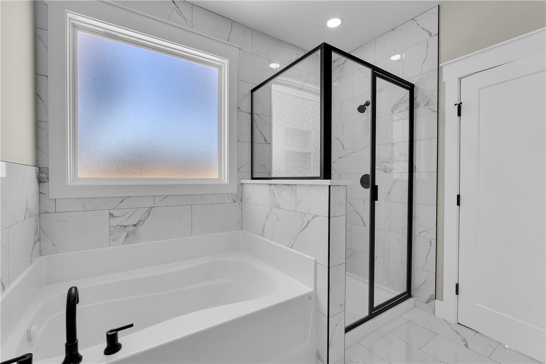 2816 Smith McGee Road Iva, SC 29655 - Photo 23 of 25 Indulge in a luxurious primary bathroom, boasting a spacious soaking tub and a sleek, glass-enclosed shower.