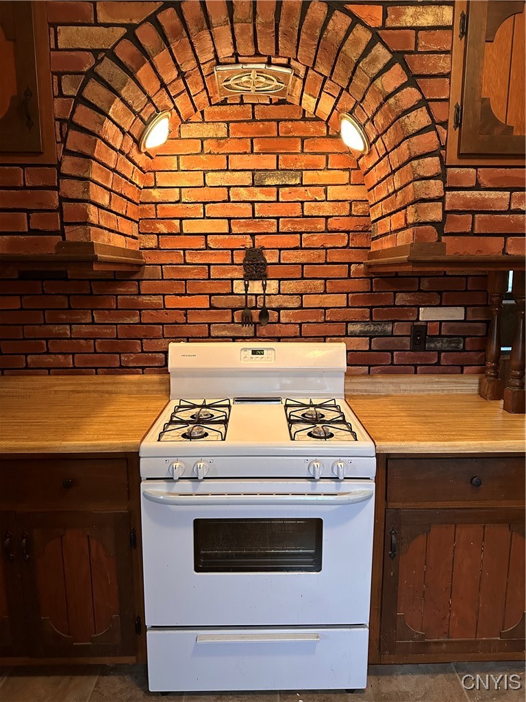 3483 Bishop Road Madison, NY 13402 - Photo 16 of 36 Brickwork displays cooking area of kitchen