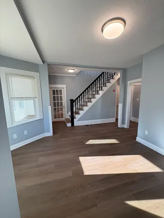 a view of entryway and hall with wooden floor