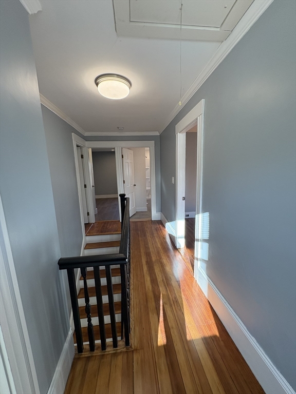 47 Marsh Road Needham, MA 02492 - Photo 14 of 20 a view of a hallway with wooden floor and staircase