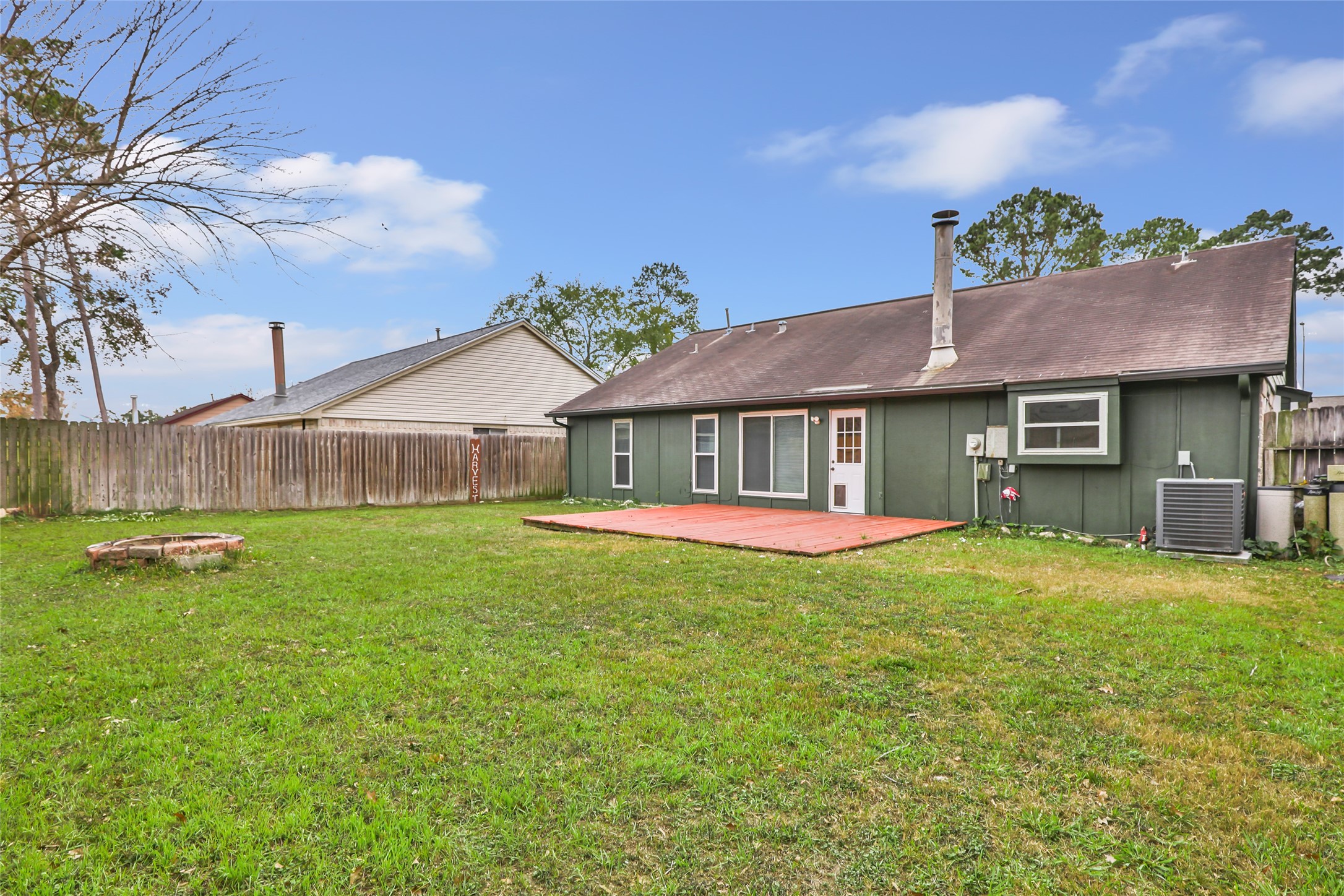 8315 Old Maple Lane Humble, TX 77338 - Photo 18 of 19 Large backyard with wood deck and plenty of room for family gatherings, playtime, or even a pool!