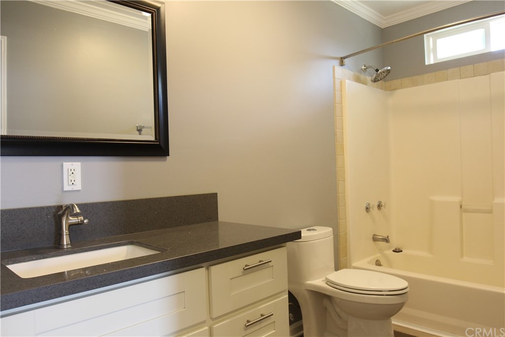 4944 Bleecker Street Baldwin Park, CA 91706 - Photo 11 of 11 a bathroom with a granite countertop sink mirror vanity and toilet