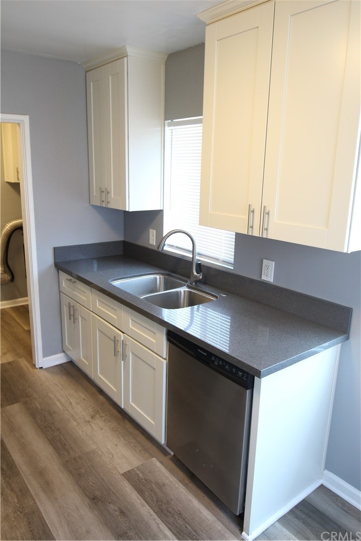 4944 Bleecker Street Baldwin Park, CA 91706 - Photo 5 of 11 a kitchen with stainless steel appliances granite countertop a sink a stove and a microwave