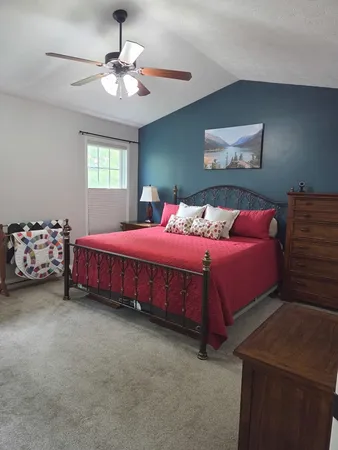 a bedroom with a bed and a chandelier