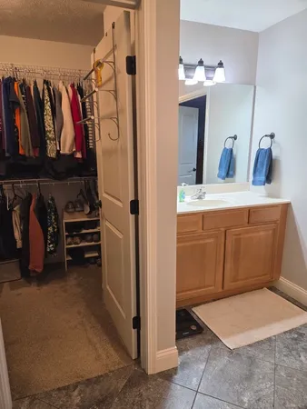 a view of walk in closet with clothes and shoes