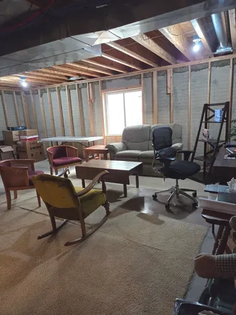 a living room with furniture a air conditioner and a window