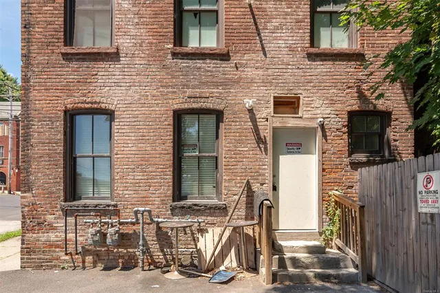 a view of a brick house with large windows