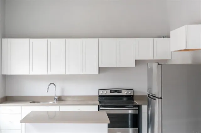 a kitchen with appliances a sink and cabinets