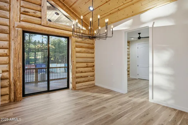 a kitchen with a stove kitchen island wooden floor and refrigerator
