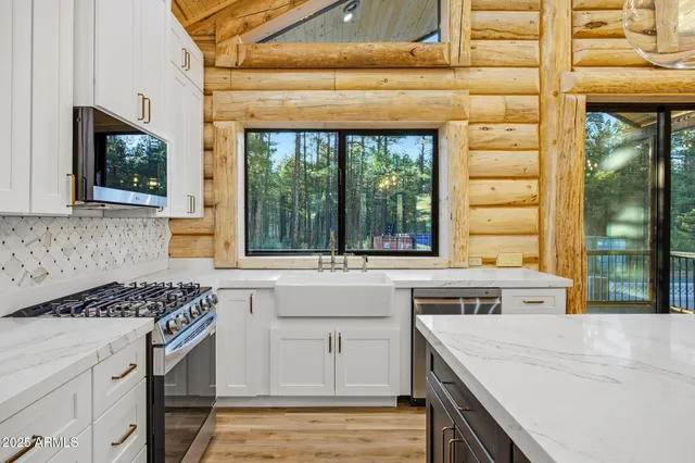 a view of a room with wooden floor and windows