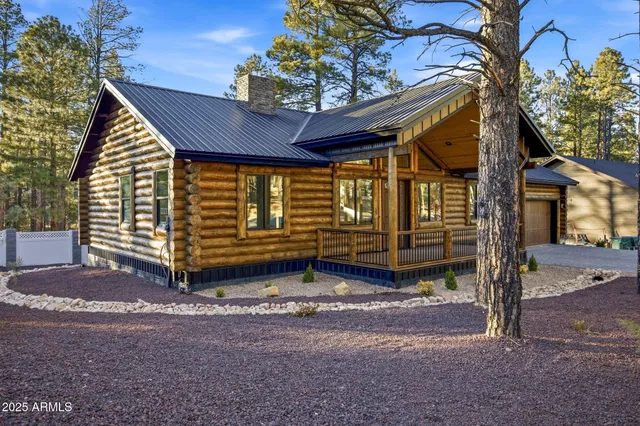 a view of a house with a small yard and wooden fence