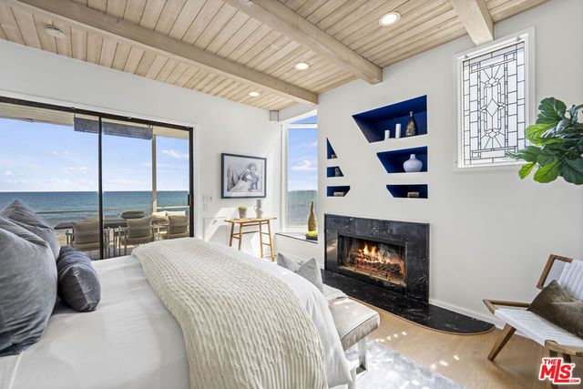 a bedroom with a large bed and a wooden floor