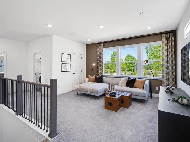 a spacious bedroom with a large bed and a large window