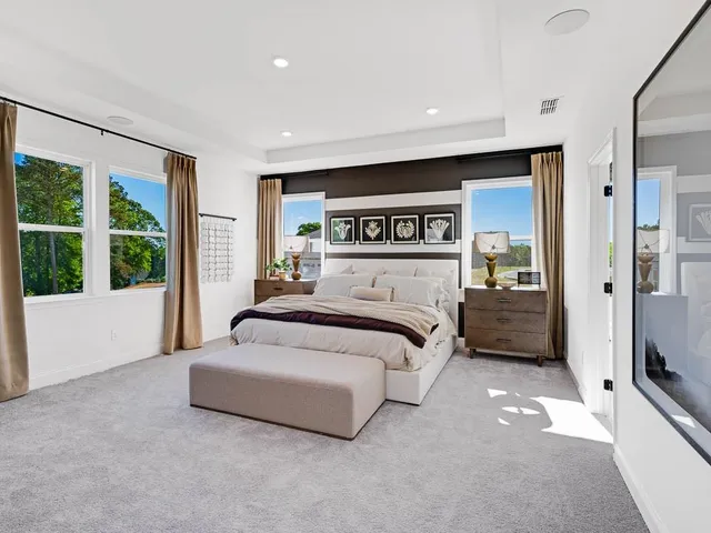 a spacious bathroom with a double vanity sink a mirror and a bathtub