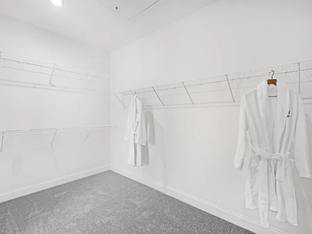 a bedroom with bed and wooden floor