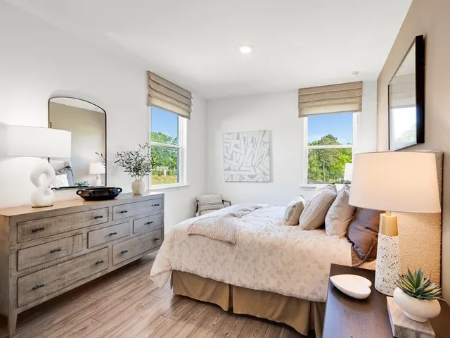 a bedroom with a bed and a lamp