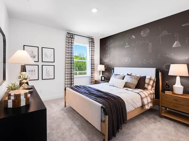 a bedroom with a bed and a night stand