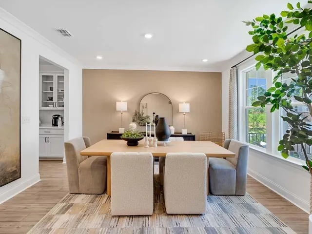 a dining room with furniture and window