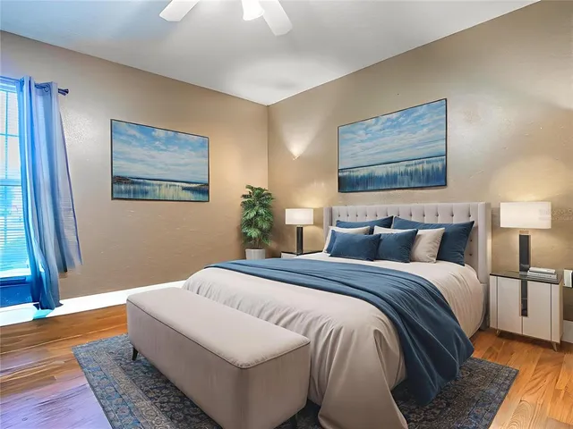 a bedroom with bed and wooden floor