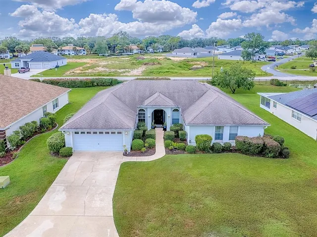 a aerial view of a house with a garden and a yard