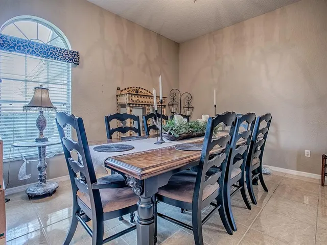 a dining room with furniture and window