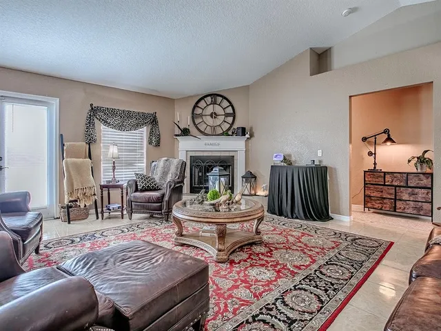 a living room with furniture a rug and a fireplace
