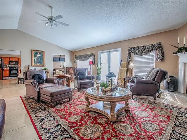 a living room with furniture a rug and a window