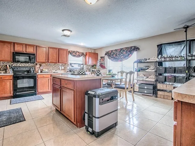 a kitchen with stainless steel appliances granite countertop a stove and a sink