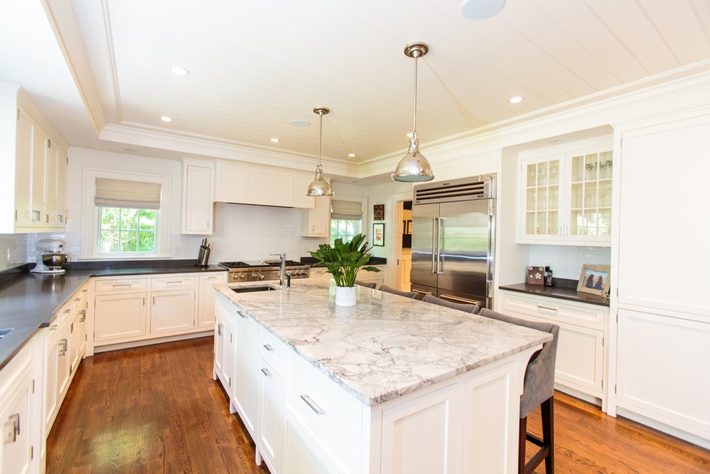35 Hundreds Road Wellesley, MA 02481 - Photo 12 of 27 a large kitchen with kitchen island a large counter top space a sink stainless steel appliances and cabinets