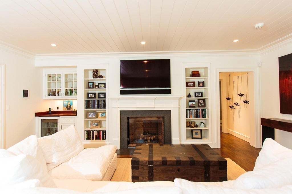35 Hundreds Road Wellesley, MA 02481 - Photo 9 of 27 a living room with furniture a flat screen tv and a fireplace