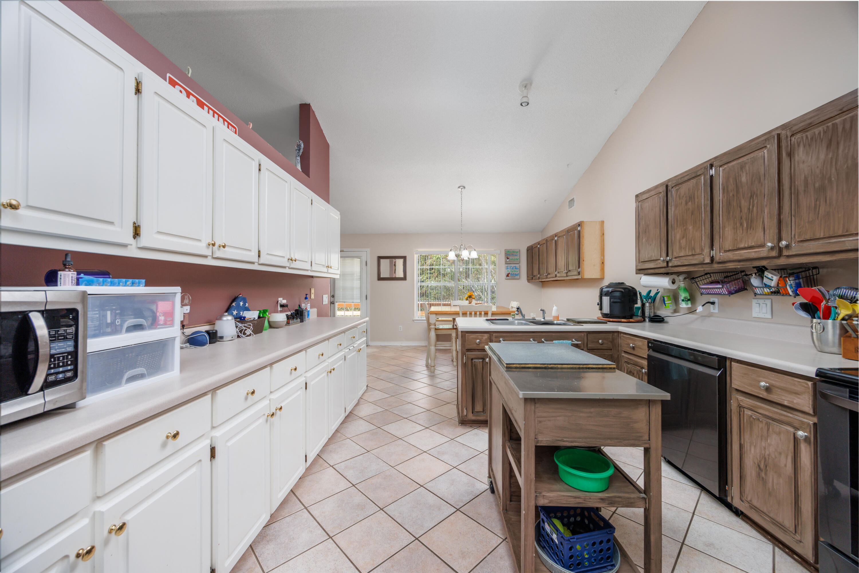 4860 Orlimar Street Crestview, FL 32536 - Photo 15 of 36 a kitchen with kitchen island granite countertop a sink a stove and cabinets