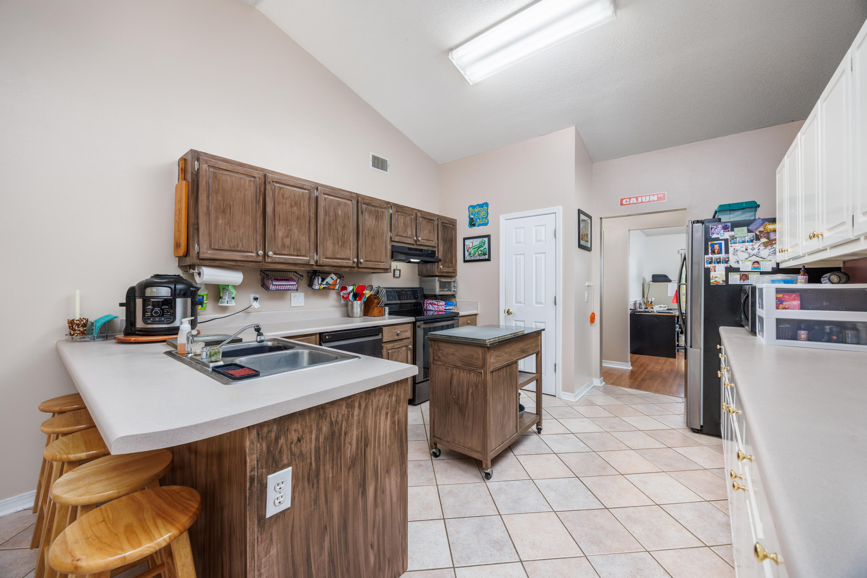 4860 Orlimar Street Crestview, FL 32536 - Photo 16 of 36 a kitchen with stainless steel appliances a stove refrigerator sink and cabinets