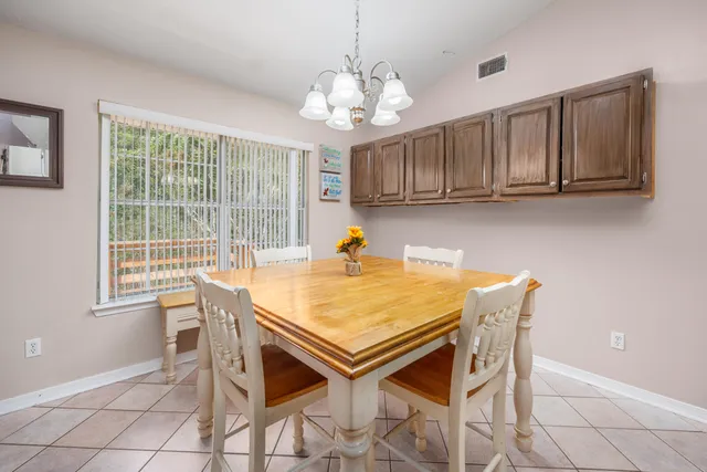 a view of a dining room with furniture and a chandelier