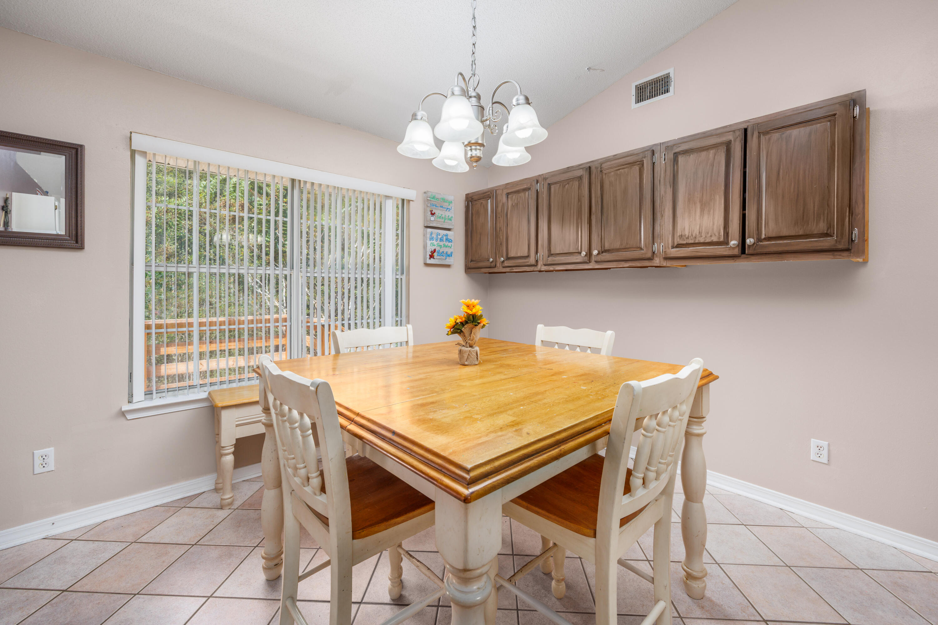 4860 Orlimar Street Crestview, FL 32536 - Photo 18 of 36 a view of a dining room with furniture and a chandelier