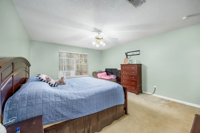 a bedroom with bed and window