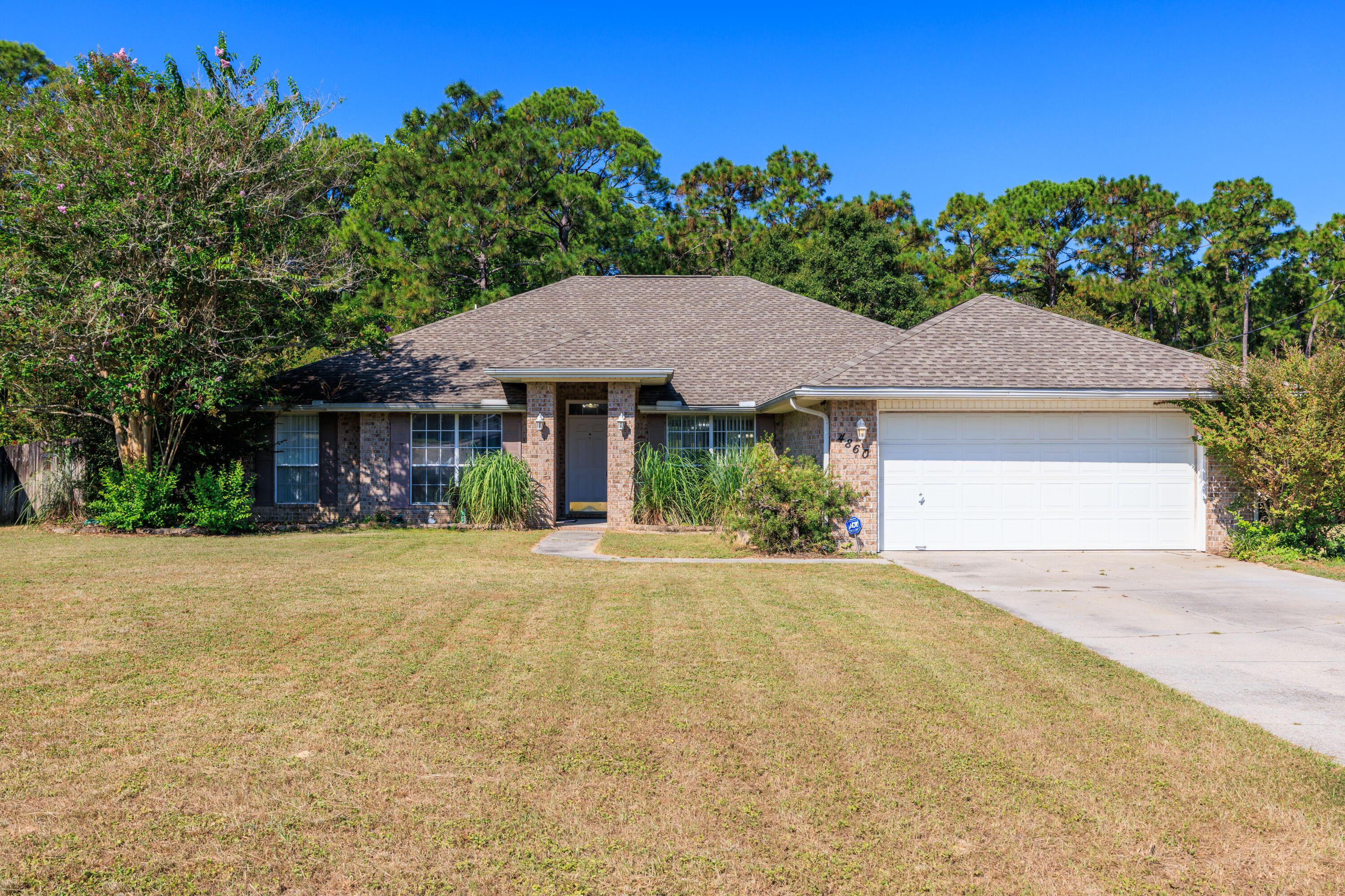 4860 Orlimar Street Crestview, FL 32536 - Photo 2 of 36 a front view of a house with a yard and garage