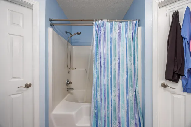 a bathroom with a shower and a tub