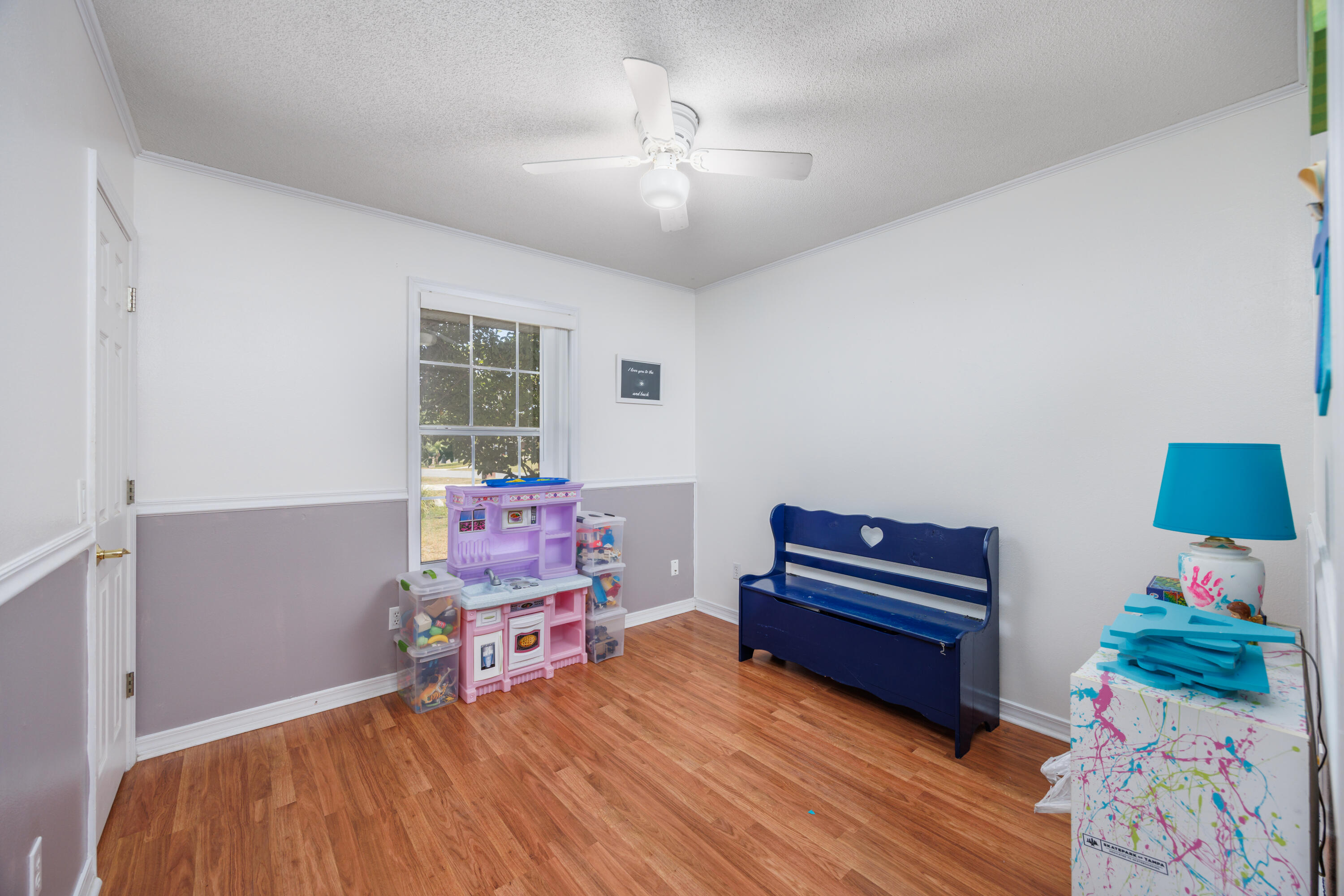 4860 Orlimar Street Crestview, FL 32536 - Photo 26 of 36 a room with furniture and a wooden floor
