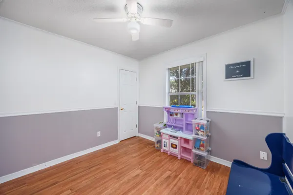 a bedroom with furniture and wooden floor