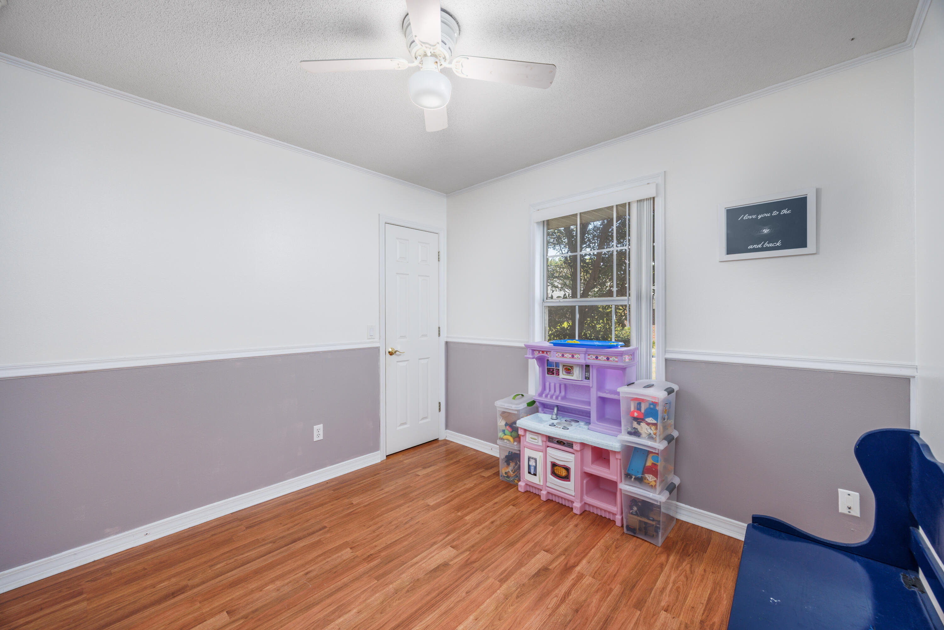 4860 Orlimar Street Crestview, FL 32536 - Photo 27 of 36 a bedroom with furniture and wooden floor