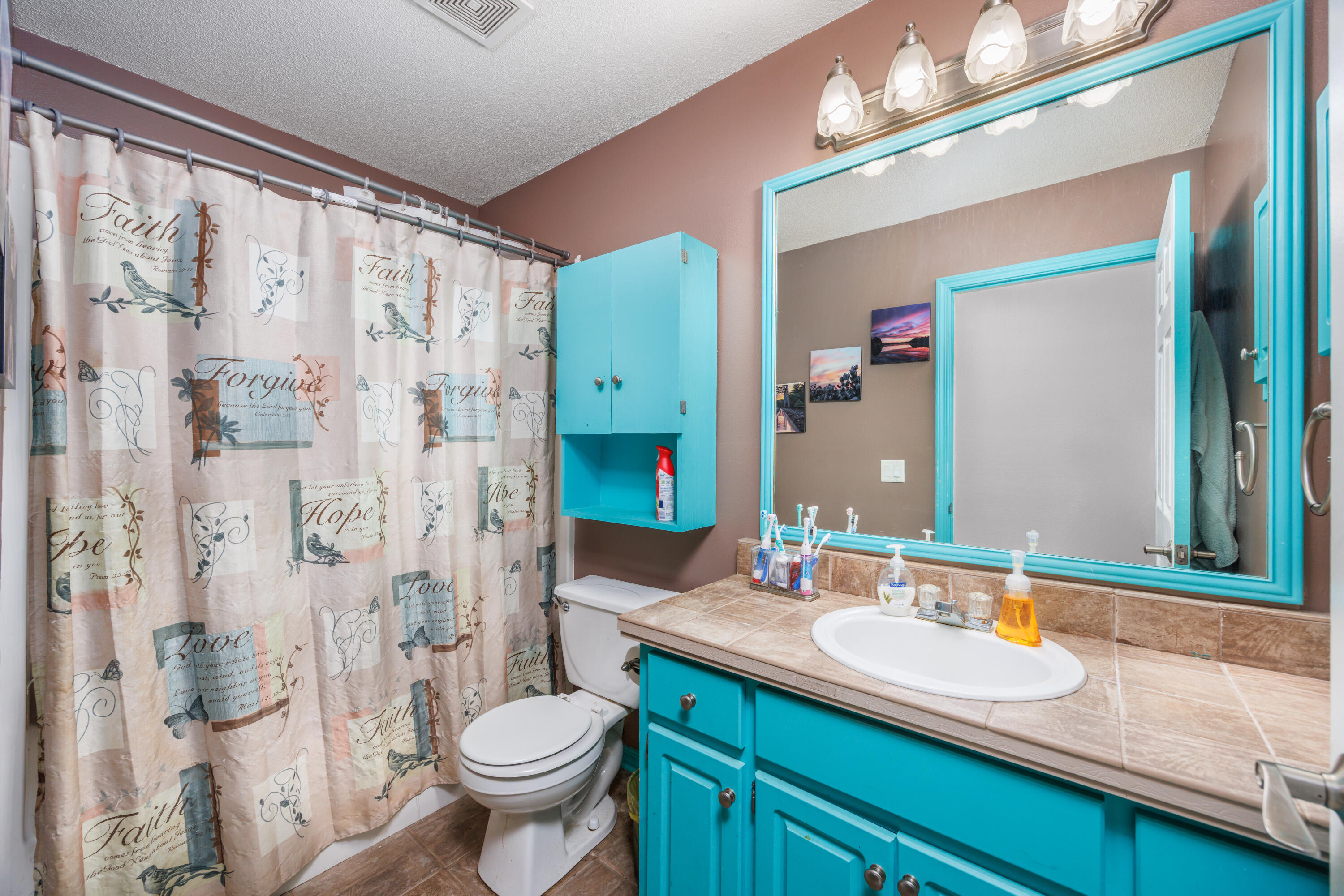 4860 Orlimar Street Crestview, FL 32536 - Photo 28 of 36 a bathroom with a granite countertop sink toilet and shower